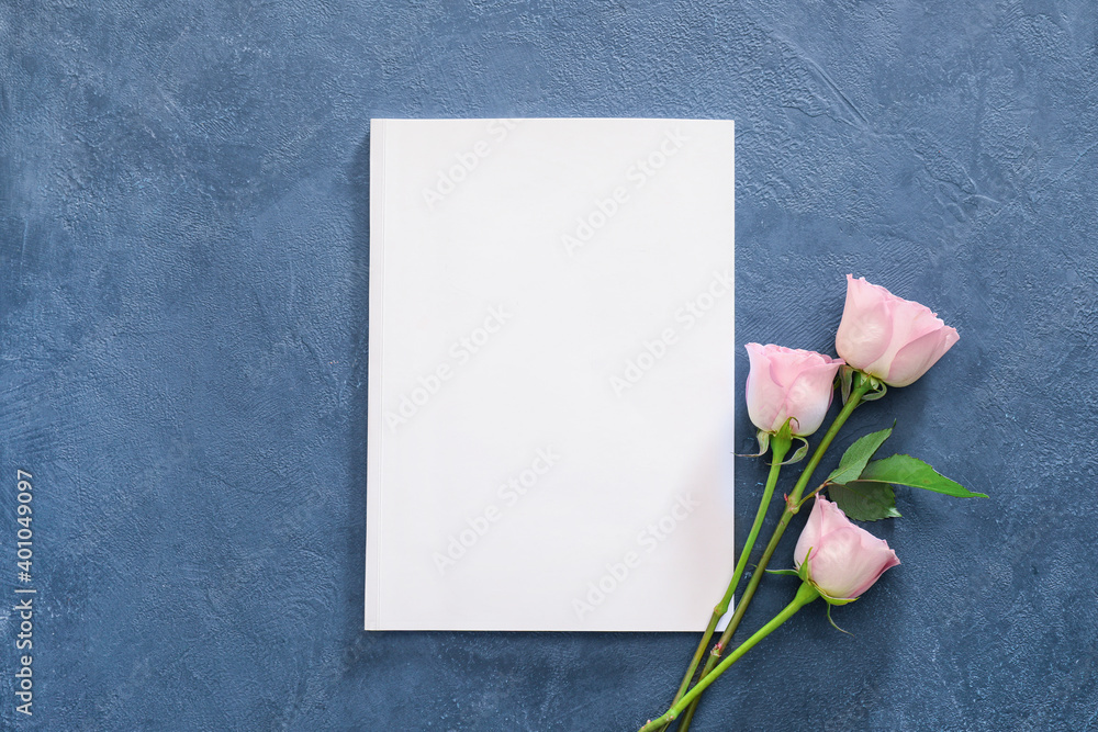 Blank magazine and flowers on color background