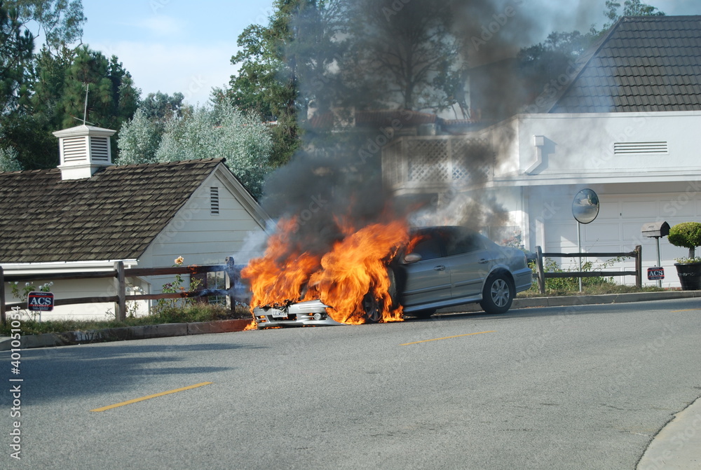 Vehicle in flames in a residential street