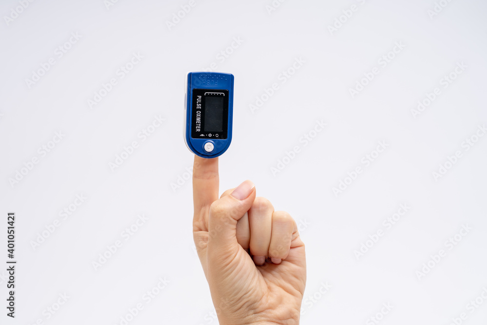 Fingertip Pulse Oximeter on finger. On white background. Device for self health diagnostic Fingertip Pulse Oximeter on finger. On white background. Device for self health diagnostic