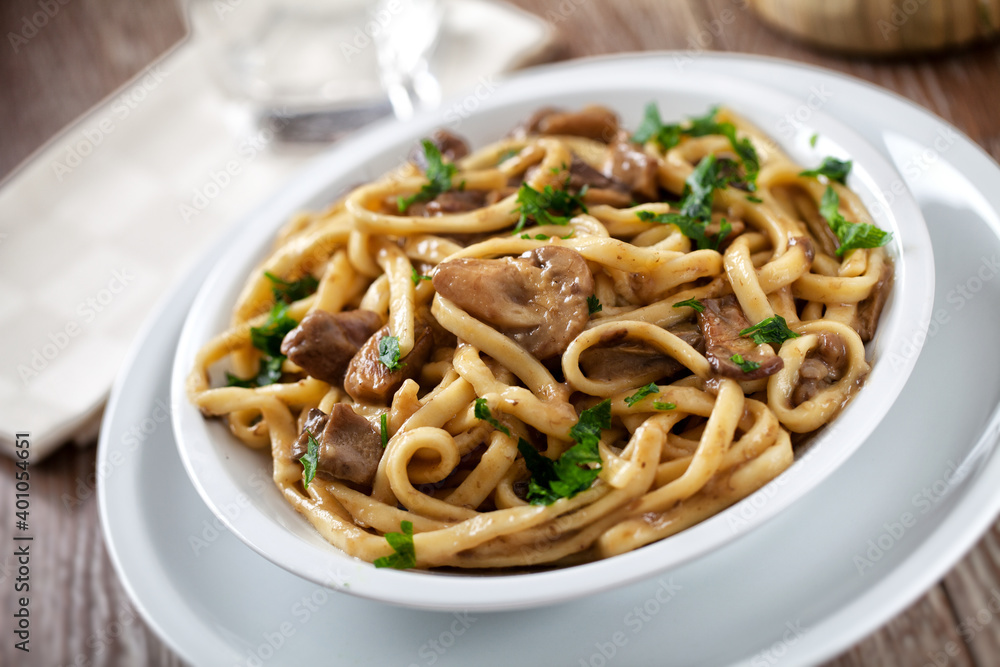 Tagliatelle with mushrooms on a plate. High quality photo.