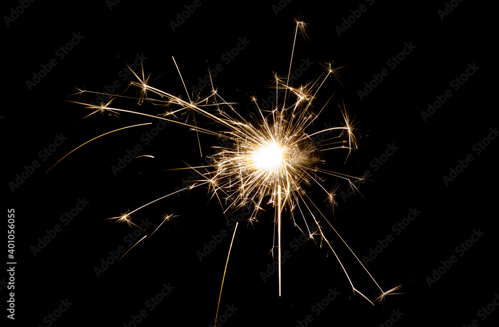 New Year's Eve celebration with a sparkler, isolated on black background.