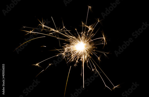 New Year s Eve celebration with a sparkler  isolated on black background.