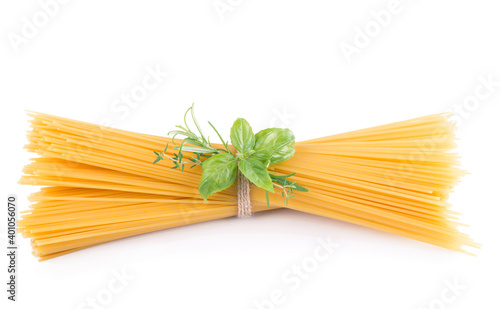 Raw tagliatelle pasta and basil isolated on white background.