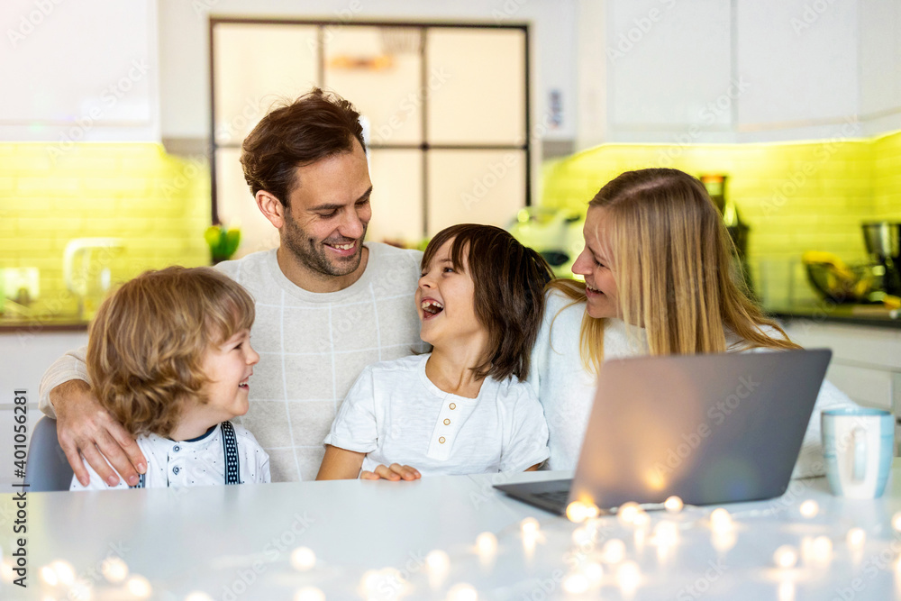 Happy young family using laptop at home
Happy young family using laptop at home
