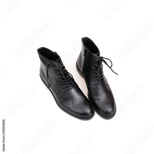 Fashionable black boots for men and women isolated on white background © Elena