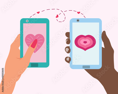 Fototapeta Naklejka Na Ścianę i Meble -  Love message on a smartphone. Send hearts by phone for valentine's day. A guy and a girl hold phones in their hands and congratulate each other on Valentine's Day
