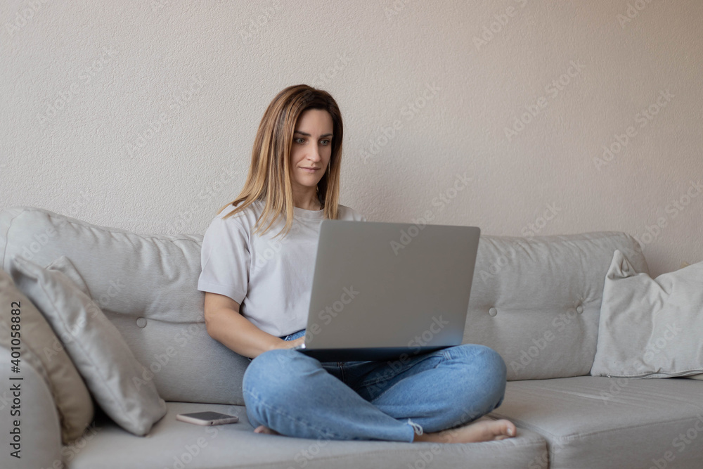 Young woman sitting on the sofa with laptop. Young woman sitting on the sofa with laptop.