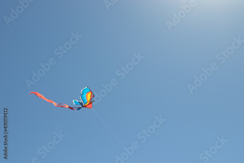 Kite soars in the blue sky. Copy space background. Freedom concept