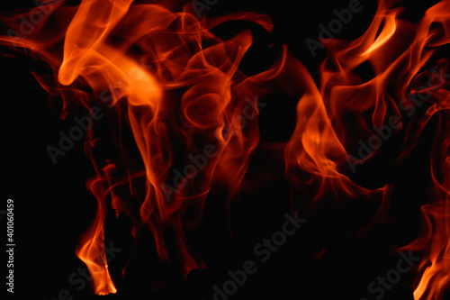 Abstract fire flame in fireplace, texture for background. Beautiful bright orange flames flicker in the darkness of the night. © Trik