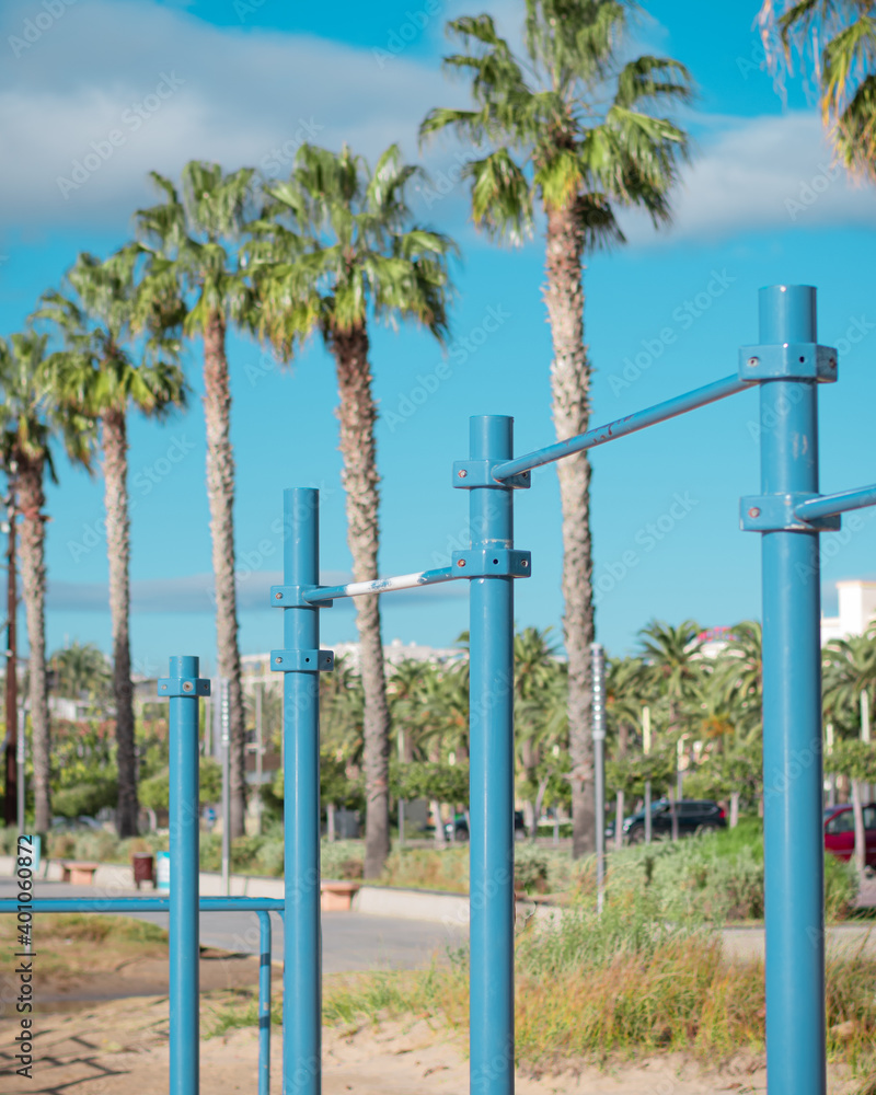 Calisthenics park on the beach. Outdoor gym with bars and palm trees on the background. Calisthenics park on the beach. Outdoor gym with bars and palm trees on the background.
