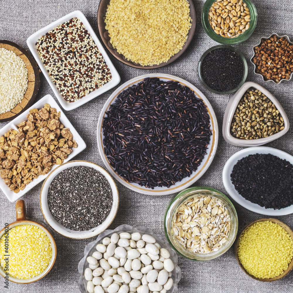 Food background of various cereals and grains in plates on a canvas Food background of various cereals and grains in plates on a canvas