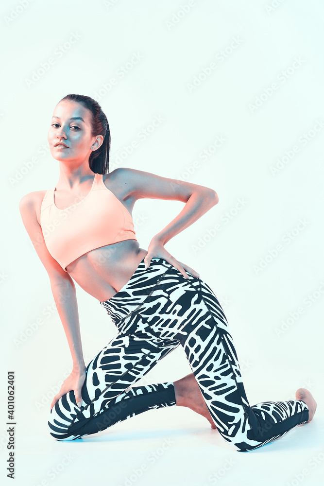 Sporty fit girl in stylish sportswear in neon light. Leggings for effective workout, healthy sport lifestyle Sporty fit girl in stylish sportswear in neon light. Leggings for effective workout, healthy sport lifestyle