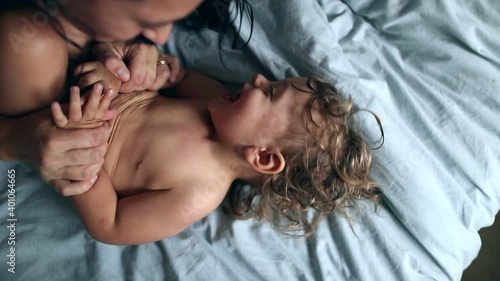 Parent tickling baby boy toddler. Adorable one year old child being tickled