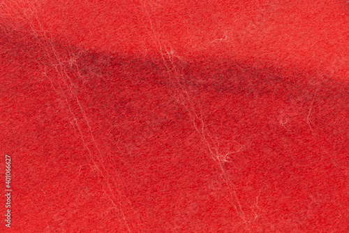 Texture of the crumpled surface of red paper. Empty background.