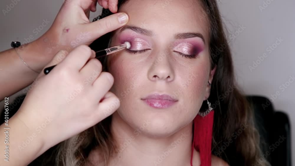 Make-up artist puts eye shadow on a beautiful model. Makeup process of applying eyeshadow powder. Beautiful woman face. basic makeup. Beauty fashion. Eyelashes. Cosmetic Eyeshadow. close up. Make-up artist puts eye shadow on a beautiful model. Makeup process of applying eyeshadow powder. Beautiful woman face. basic makeup. Beauty fashion. Eyelashes. Cosmetic Eyeshadow. close up.