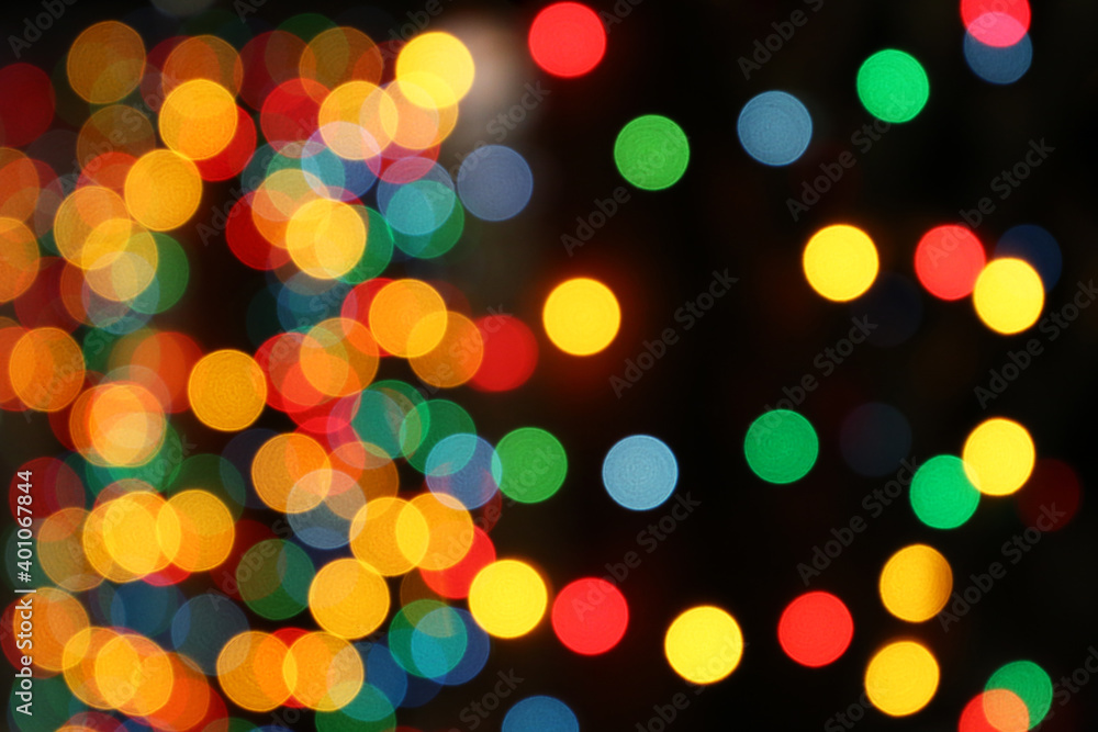 Christmas lights, defocused colorful abstract background. Blurred bokeh with golden, green, red and blue shining lights, New Year holiday texture, decorations on the night street Christmas lights, defocused colorful abstract background. Blurred bokeh with golden, green, red and blue shining lights, New Year holiday texture, decorations on the night street