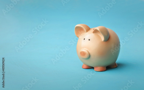 piggy bank on blue background © olly
