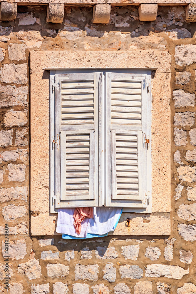 Summer cityscape - view of the window closed from the heat by shutters in the Old Town of Dubrovnik on the Adriatic Sea coast of Croatia