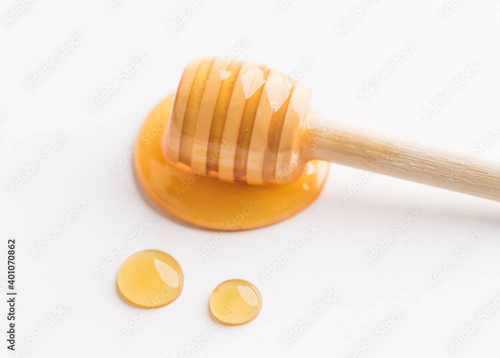 Honey dripping off a wooden honey dipper. Honey dripping off a wooden honey dipper.