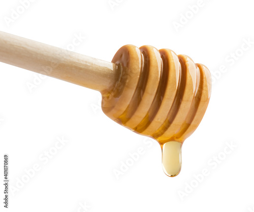 Honey dripping off a wooden honey dipper.