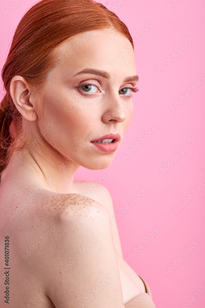 redhead shirtless woman posing isolated over pink background, look at camera having charming face redhead shirtless woman posing isolated over pink background, look at camera having charming face