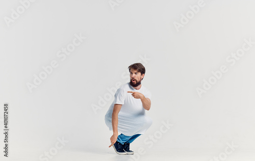 Cheerful bearded man in white t-shirt and jeans emotions studio lifestyle fun