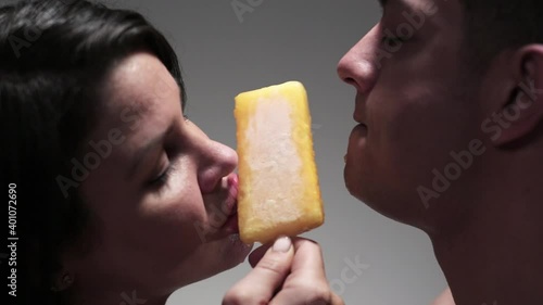 Man and woman sensually sharing flavored ice photo