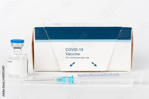 Medical concept, syringe with needle, vial and paper box with Covid-19 vaccines photo