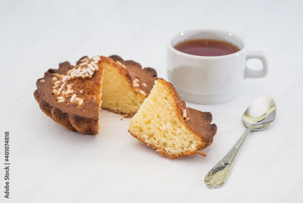  cupcake and a cup of tea on a white background.