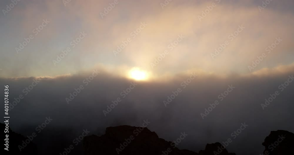 Zoom in past person enjoying sunrise on Haleakala Crater Zoom in past person enjoying sunrise on Haleakala Crater