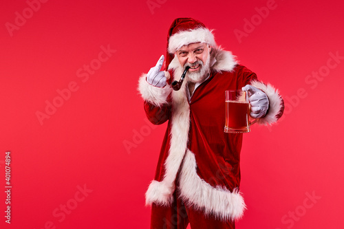 angry bad santa man smoking, drinking beer and showing fuck gesture at camera, isolated