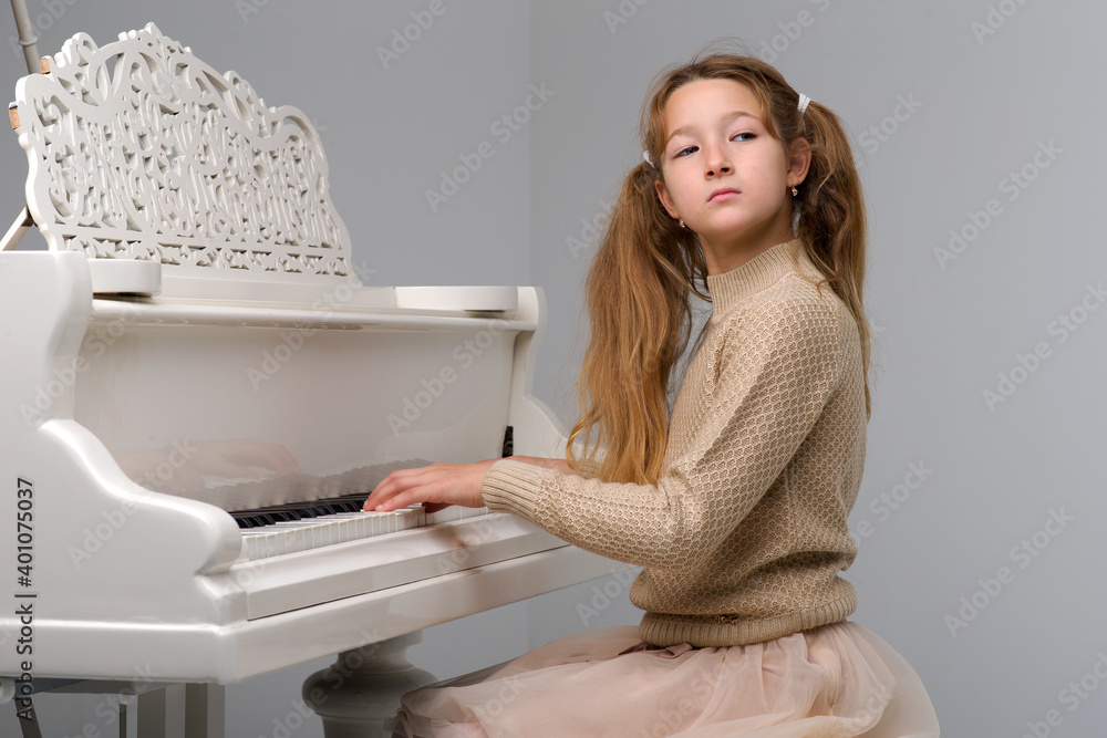 Beautiful teenage girl playing grand piano Beautiful teenage girl playing grand piano