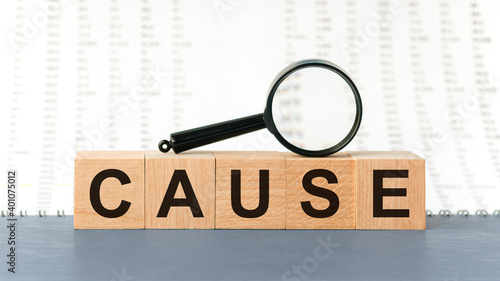 Wooden blocks with the text: cause with magnifying glass