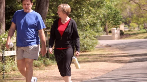 Man and woman walking in neighborhood street photo