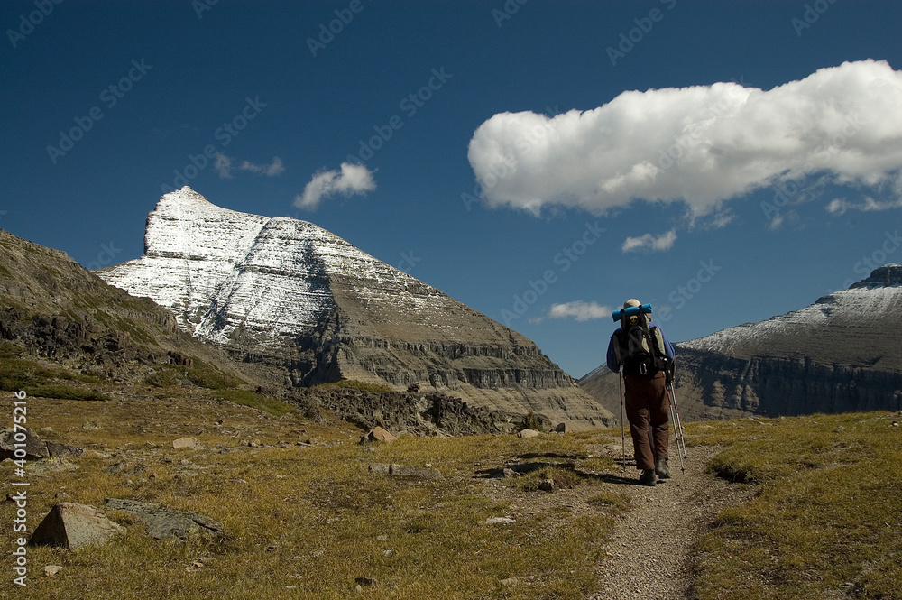 Lone hiker on mountain trail in Glacier national park
