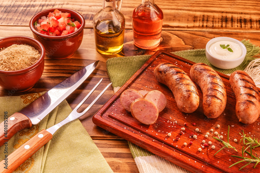 Brazilian pork sausage with BBQ fork and knife - Churrasco de linguiça de suina