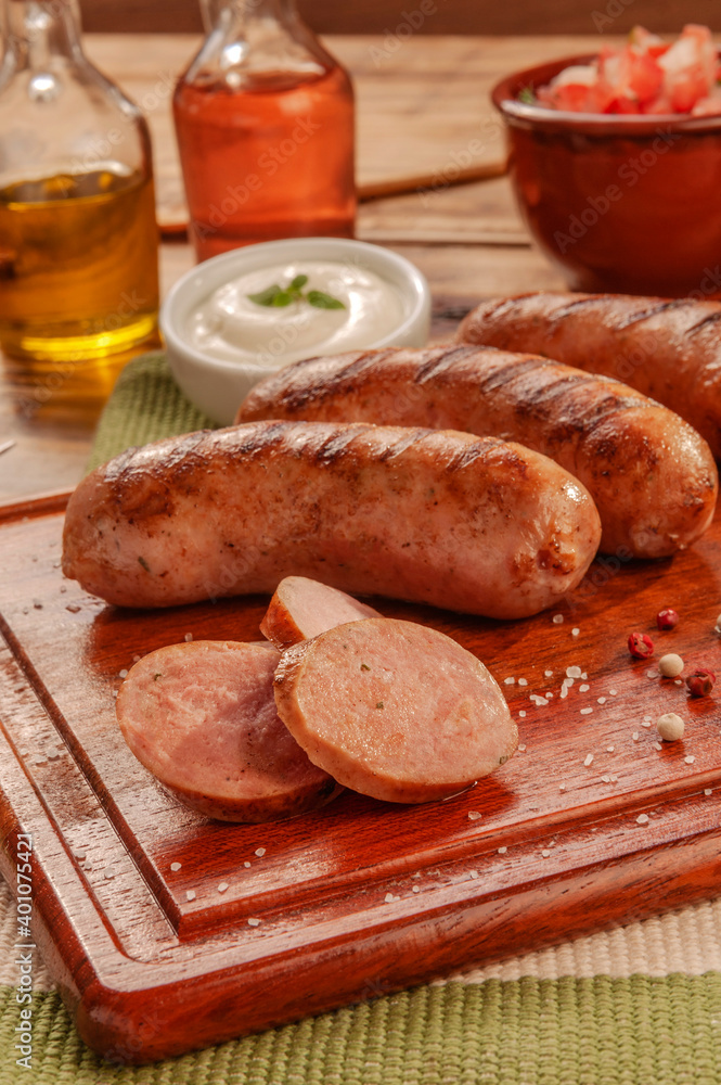 Brazilian pork sausage BBQ - Churrasco de linguiça de suina close up Brazilian pork sausage BBQ - Churrasco de linguiça de suina close up