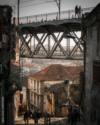 Fototapeta Naklejka Na Ścianę i Meble -  Traditional old houses in Ribeira and stairs down to the river Douro, Dom Luis I or Luiz I iron bridge on the background, Porto, Portugal