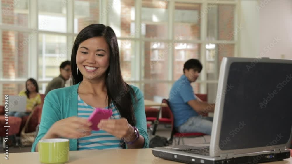 Woman in cafe celebrating good news on cell phone Woman in cafe celebrating good news on cell phone