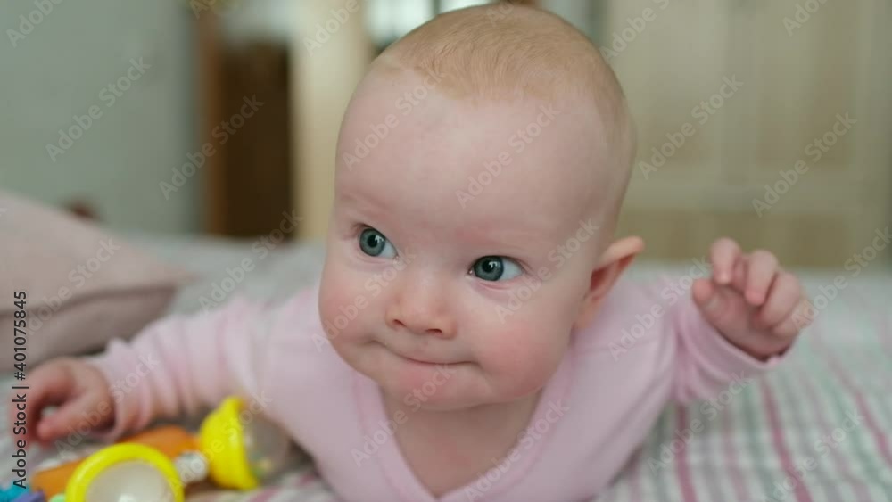 Close-up portrait face of beautiful caucasian sweet little baby looking at camera. Concept of care happy family and child children baby parenthood childhood motherhood, Little girl on bed in home room Close-up portrait face of beautiful caucasian sweet little baby looking at camera. Concept of care happy family and child children baby parenthood childhood motherhood, Little girl on bed in home room