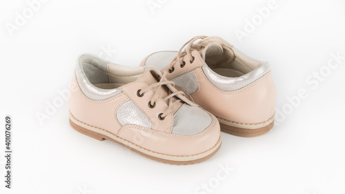 children's beige orthopedic shoes on a white background