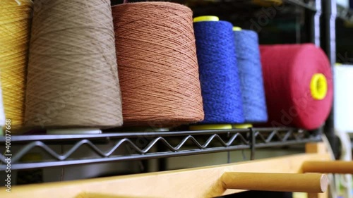 Multicolor spools of thread on shelves photo