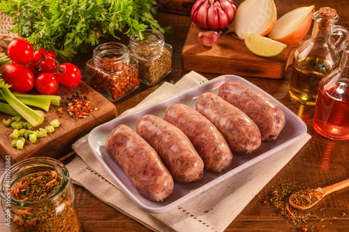 Brazilian pork sausage with chimichurri on white plate with spices and ingredients