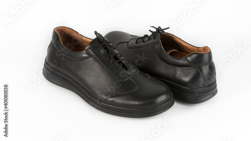 children's black orthopedic shoes on a white background © Mykola
