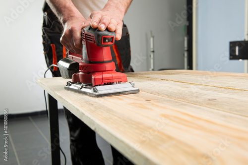 Sanding machine in male hand