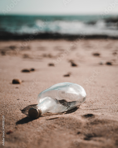 Old lost bottle on the beach in Apúlia, Braga, Portugal in the background