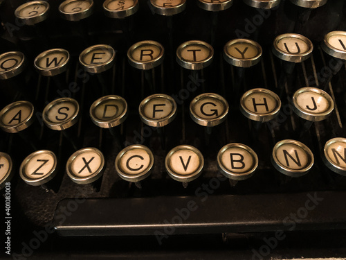 Close up of vintage typewriter keyboard, letters and spacebar, black, chrome, faded white