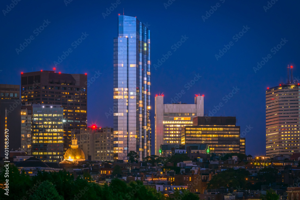 The last sunlight of the day reflects off the glass of skyscrapers