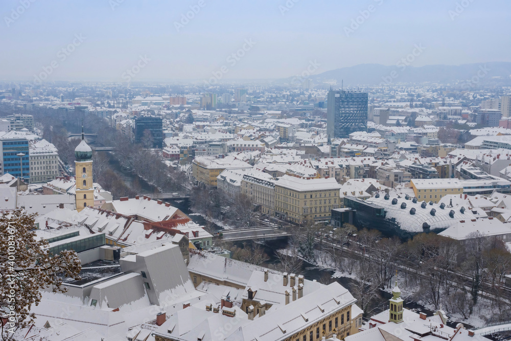 Cityscape of Graz from Schlossberg hill with historic and modern buildings, with snow, in winter, Styria region, Austria