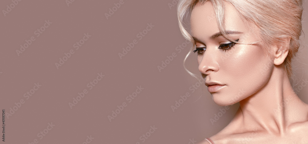 Naklejka premium Beautiful sexy Woman with luxury Make-up. Girl with blond hair on beige background. Style for Womans Day or Valentines